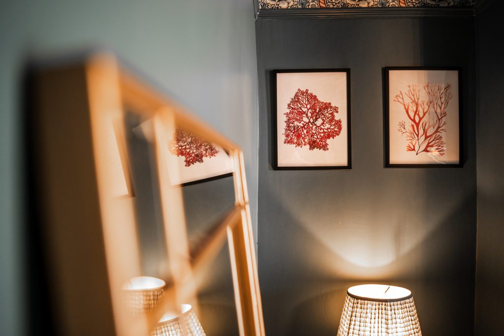 Discover a tasteful corner in this Anfield, Liverpool serviced accommodation where contemporary flair meets cosy ambience. Two framed coral prints in vibrant red hues are mounted on a deep...