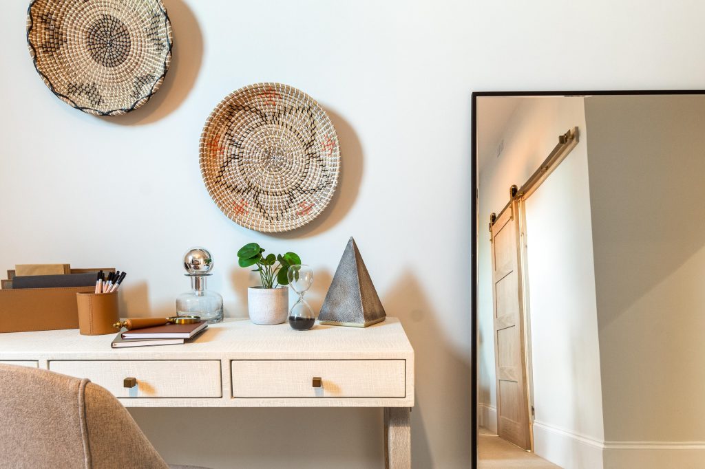 This impeccably staged home office corner in Scartho, Lincolnshire features a stylish textured desk adorned with curated decorative pieces to captivate prospective buyers. Above the desk...