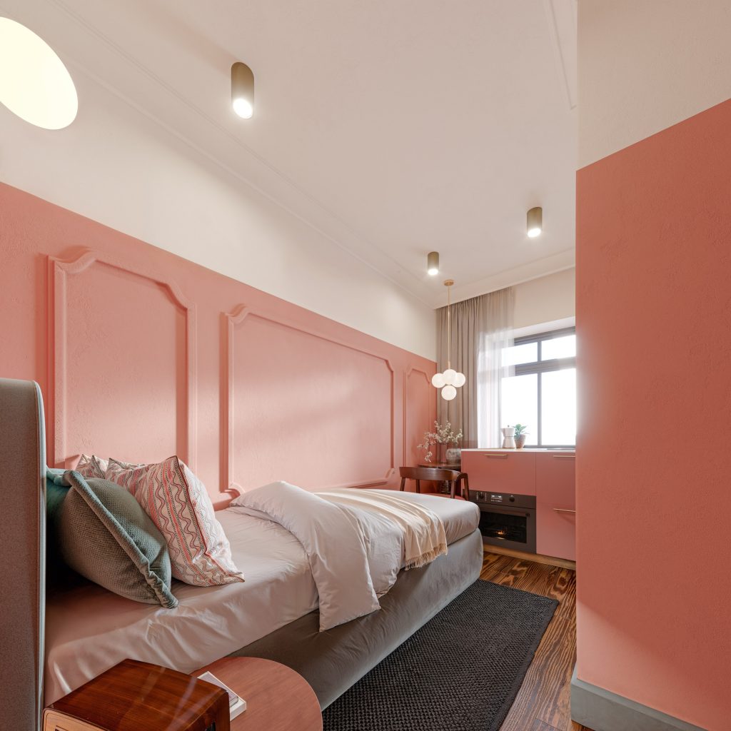 Micro studio with a coral panelled feature wall, layered bedding and a statement pendant.
