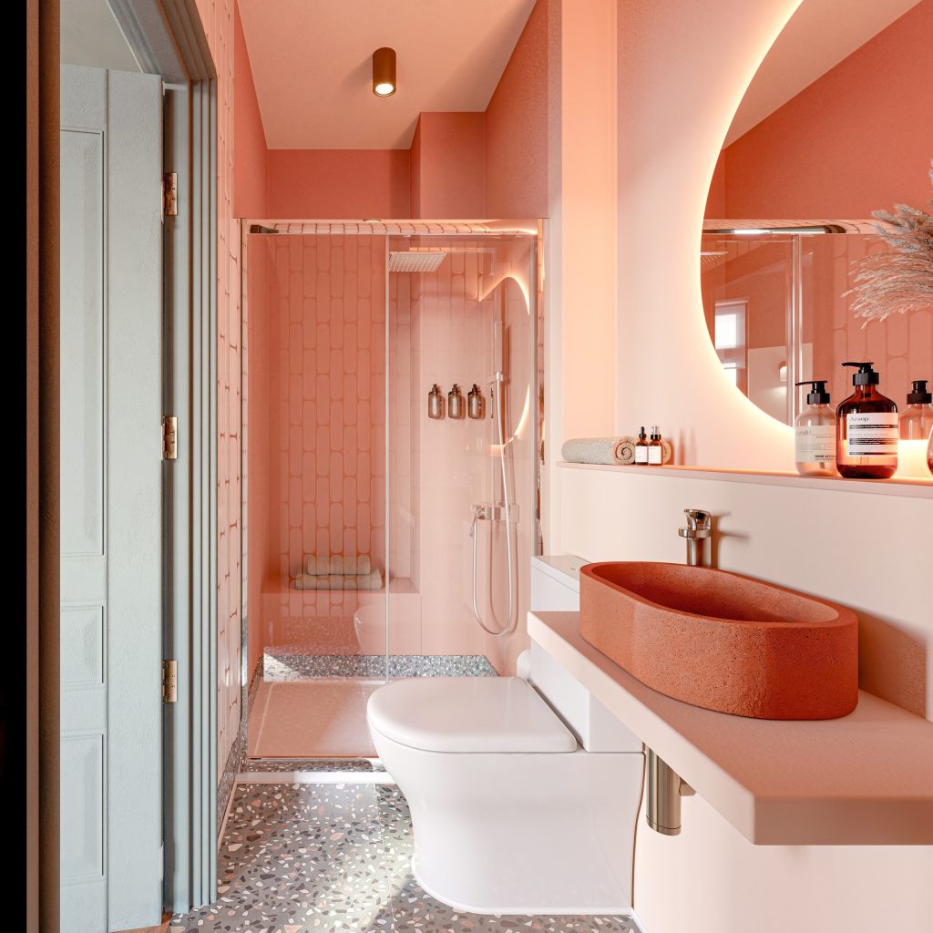 Spa-style ensuite in warm coral, with a terracotta basin, a round mirror and a walk-in shower over terrazzo flooring.