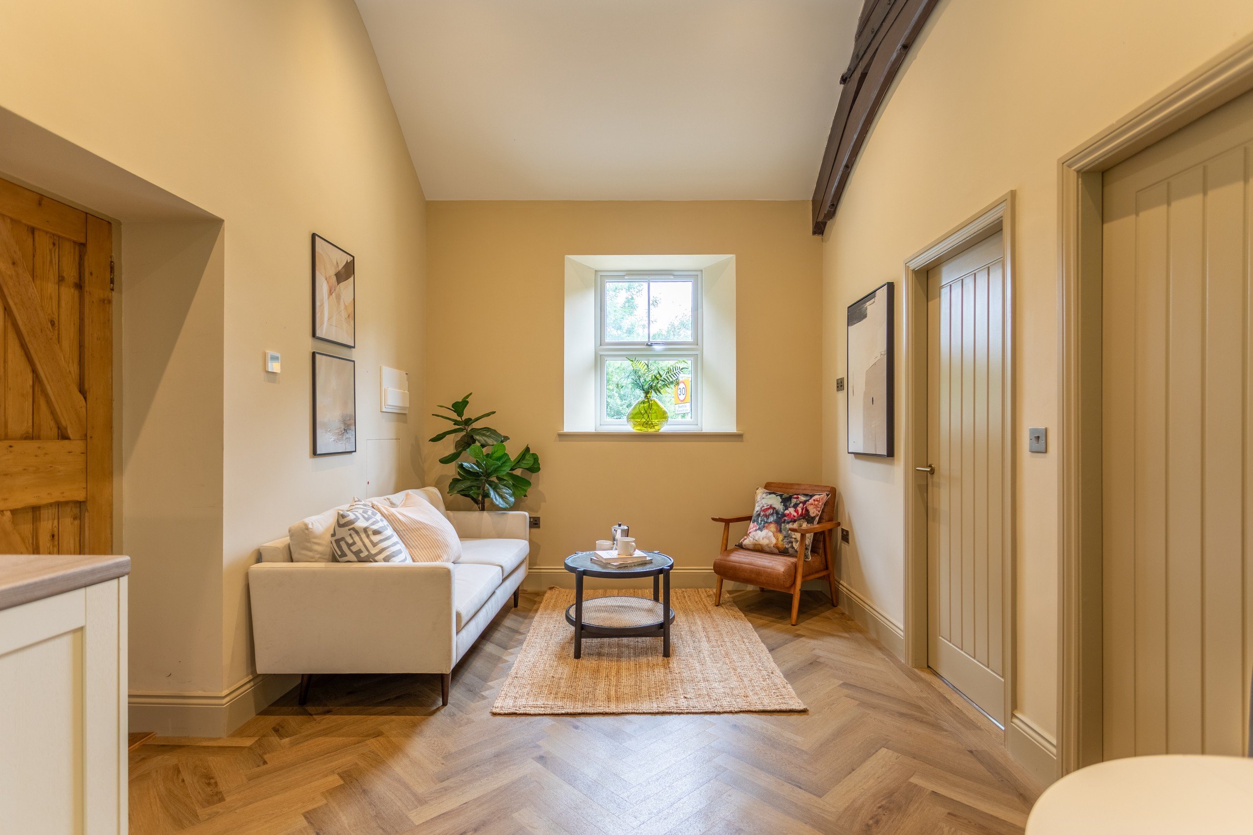 A living room styled with warm colours by WildKind.