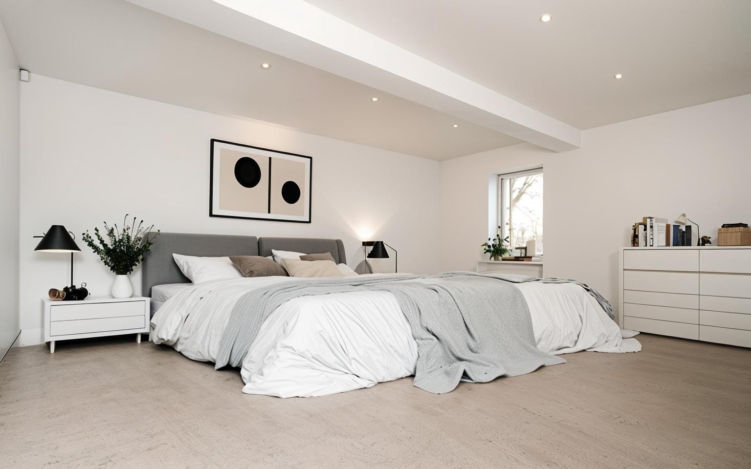 a virtually staged modern bedroom with a grey and white bed, abstract black and white art, and minimal decor. Light wood floor, bright and serene ambiance.